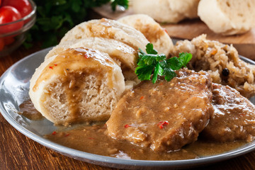 Pork loin in gravy with bread dumplings and sauerkraut