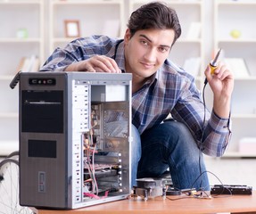 Disabled man on wheelchair repairing computer