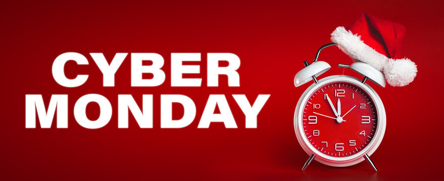 Red clock with Christmas Santa hat and Cyber Monday text. Time for Christmas shopping concept.