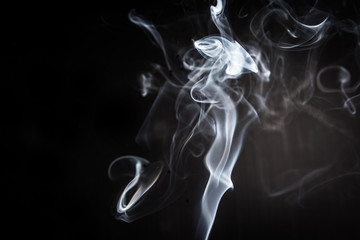 Abstract smoke swirls on black