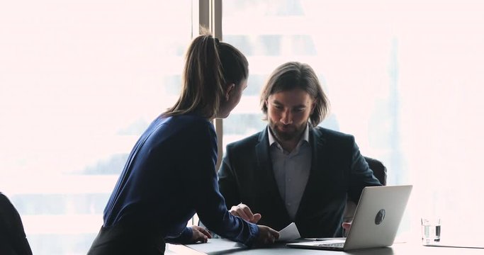 Businessman employer greeting interviewing young businesswoman job seeker