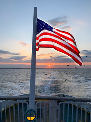 Viewing sunset with American flag from the stern of a ferry