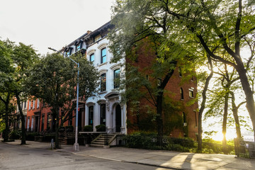 Brownstone facades & row houses at sunset in an iconic neighborhood of Brooklyn Heights in New York...