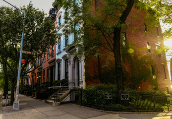 Brownstone facades & row houses at sunset in an iconic neighborhood of Brooklyn Heights in New York City