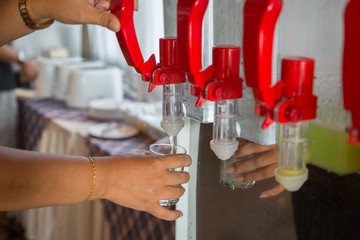 Hand turns on faucet of cold drinking water