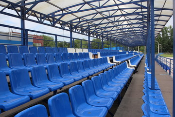 Fototapeta premium long rows of blue empty seats in the stadium for spectators