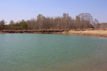 picturesque lake in nature near the forest in spring