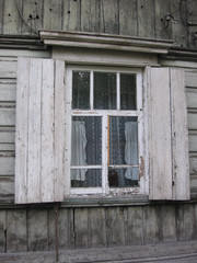 old wooden rural house with an open window, historical monument