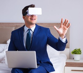 Businessman wearing a virtual reality headset in the bedroom