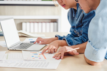 close up hand creative designer team casual meeting and brainstroming on desk with paperwrok and online data on laptop in meeting room at modern office.business planning concept.