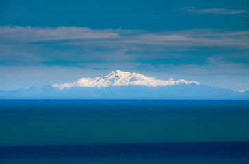 Snow caped mountain peaks in the Southern Alps viewed from the tip of the North Island  at Ngawi