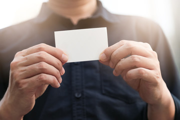 Fototapeta premium Confident male business executive with empty white business card