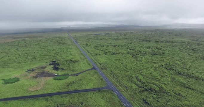 Aerial view road throught the green moss in Eldhraun lava field covered green moss in Iceland