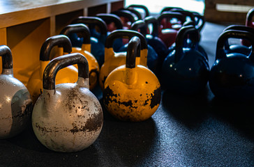 Naklejka na ściany i meble Kettlebells on gym. Close up. Work out with the kettlebells