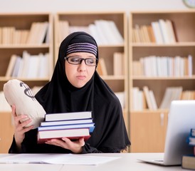 Muslim girl in hijab studying preparing for exams