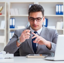 Businessman smoking in office at work