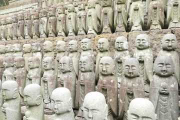 roll of Jizo Bodhisattva statues or statutes of baby buddha sat Hase-dera temple in Kamakura, Japan