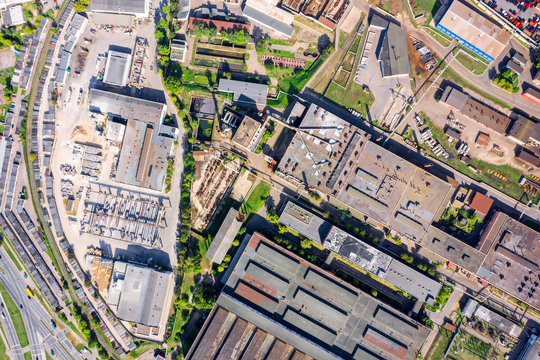 aerial top view of city industrial landscape. warehouses and storage buildings with rusty metal brown roofs