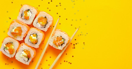 Japanese rolls on yellow background.