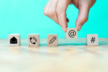 Businessman chooses icon on wooden block