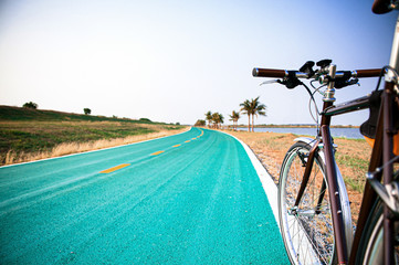 Fototapeta premium Vintage bicycle on street in nature field. Riding sport vehicle