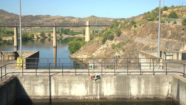 Cruise river boat finishes its entry into the lock of Barragem do Pocinho dam on the Douro ready for the descent to the lower level of the river