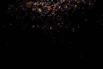 Golden sparkles, glitter on black background shine, New year concept.