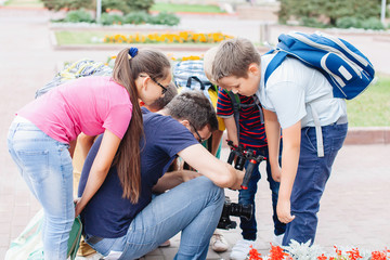 Group of teenagers leaned in a circle.