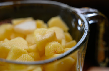 sliced and peeled apples inside a glass measuring cup