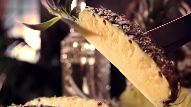 Pineapple slice lifted out of the pineapple in slow motion