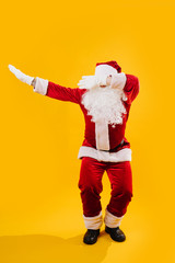 Fototapeta na wymiar Happy dancing Santa Claus squating and waving hands