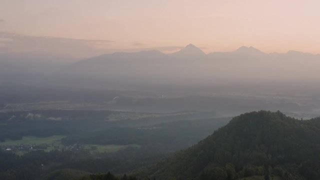 Sunrise over Jamnik, Slovenia. Aerial drone view over Alps and Church St. Primoz