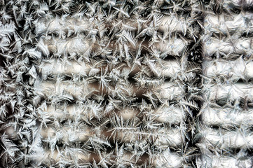 Graphic background. Abstraction. Ice lace on the glass. Detail. Close-up image.