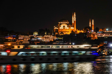 Istanbul, Turkey The Galata Bridge and the Blue Mosque illuminated at night.