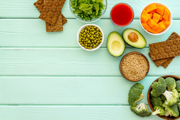 Healthy food. Vegatables and fruits on green wooden background top view frame copy space