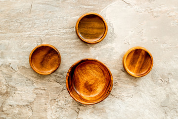 Making wooden dishes. Empty bowls on grey background top view