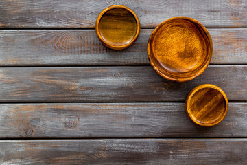Making wooden dishes. Empty bowls on dark wooden background top view copy space