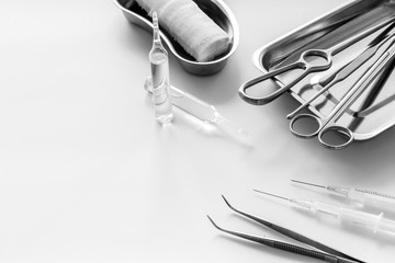 Plastic surgery instruments and tools with bandage and ampoulie on white background copy space