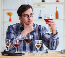 Professional sommelier tasting red wine