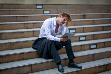 unemployed businessman stress sitting on stair, concept of business failure and unemployment problem.