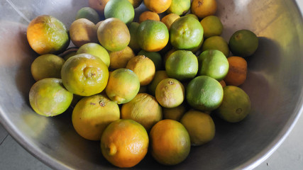 Sweet limes and oranges in bowl