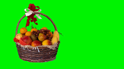 Many fruits are included in the green background basket for new year's gifts.