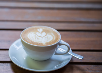 cup of coffee on wooden table