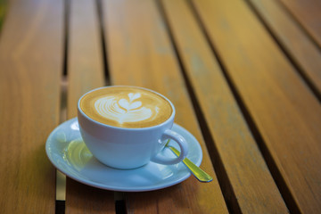 cup of coffee on wooden table