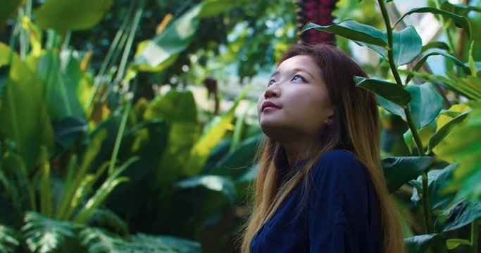 Asian Woman Looking Around Indoor Botanical Gardens