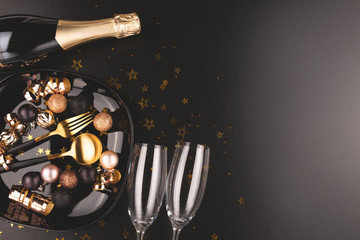 Christmas or New Year composition. Dinner arrangement. Champagne, glasses. Moody toning.