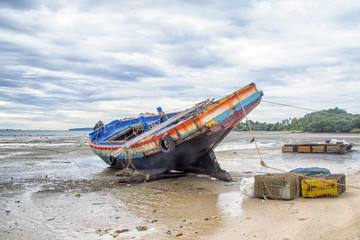 Fototapeta premium Wreck of boat moored on beach