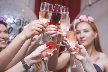 Cheerful girls clinking glasses.