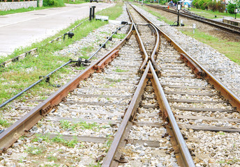 Fototapeta na wymiar Close up of Metal and Stoneware railroad with a bifurcation crossing.