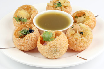 Tadeonal subcontinental street snack food chickpeas potato pani puri fuska with tamarind sauce